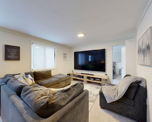 Family-friendly hotel entertainment lounge with screens and seating